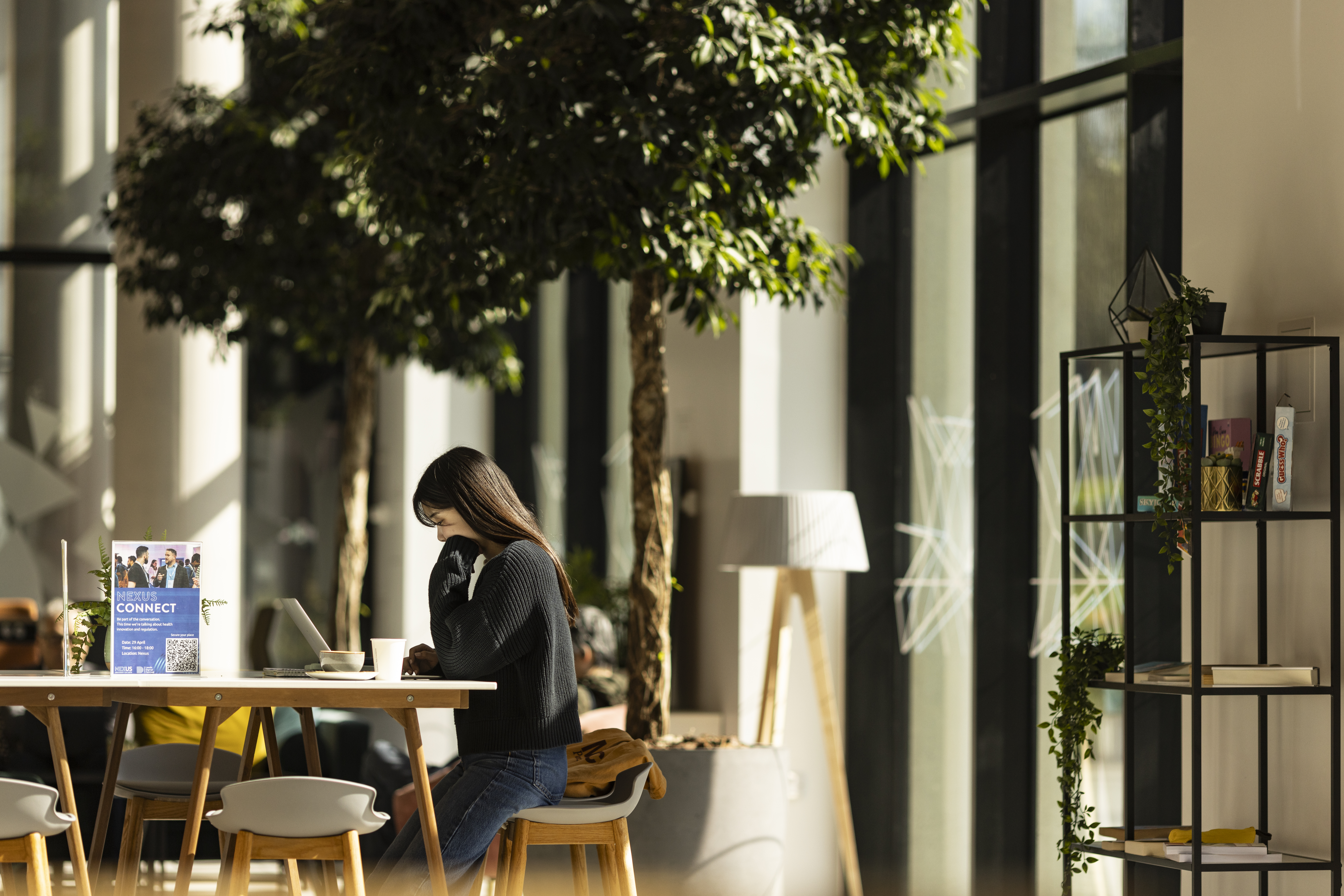 Interior of Nexus, a woman working on her laptop